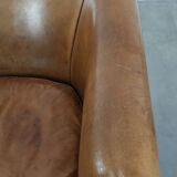 Characterful club chair made of sheepskin leather with light cognac colours