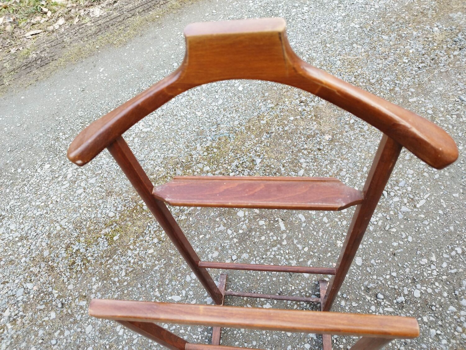 Valet wearing double wood coat rack