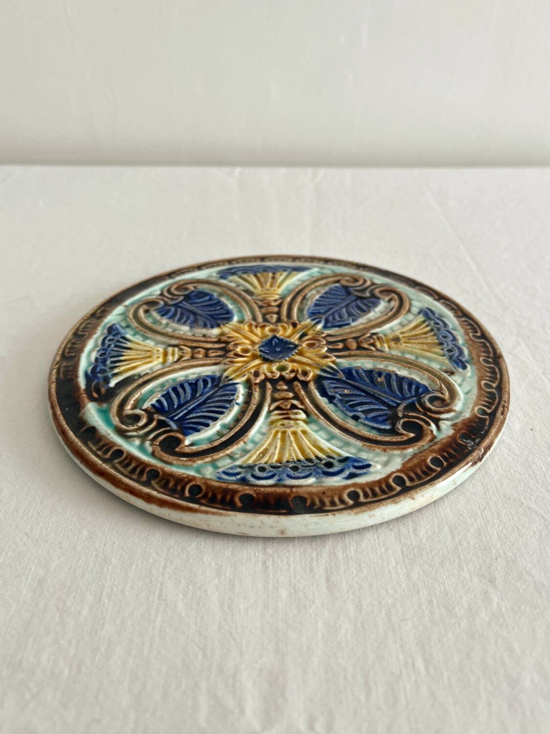 Art Nouveau earthenware bottle coaster/trivet, late 19th/early 20th century