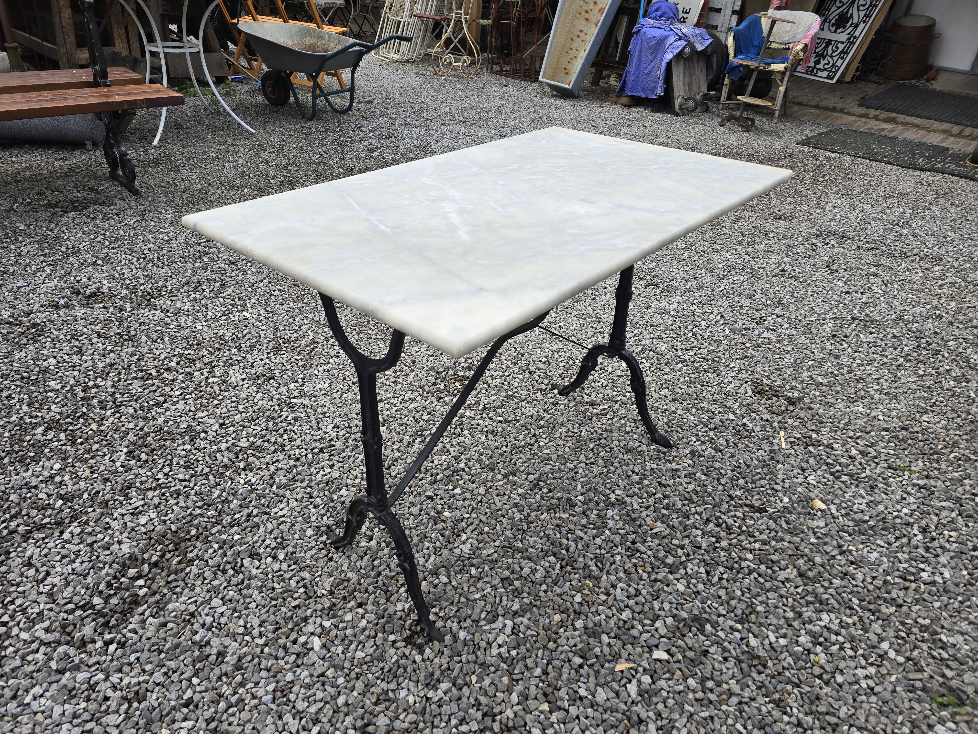 Bistro table with marble top and cast iron base