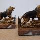 Small roaring lion bookends in patinated metal on a marble base.