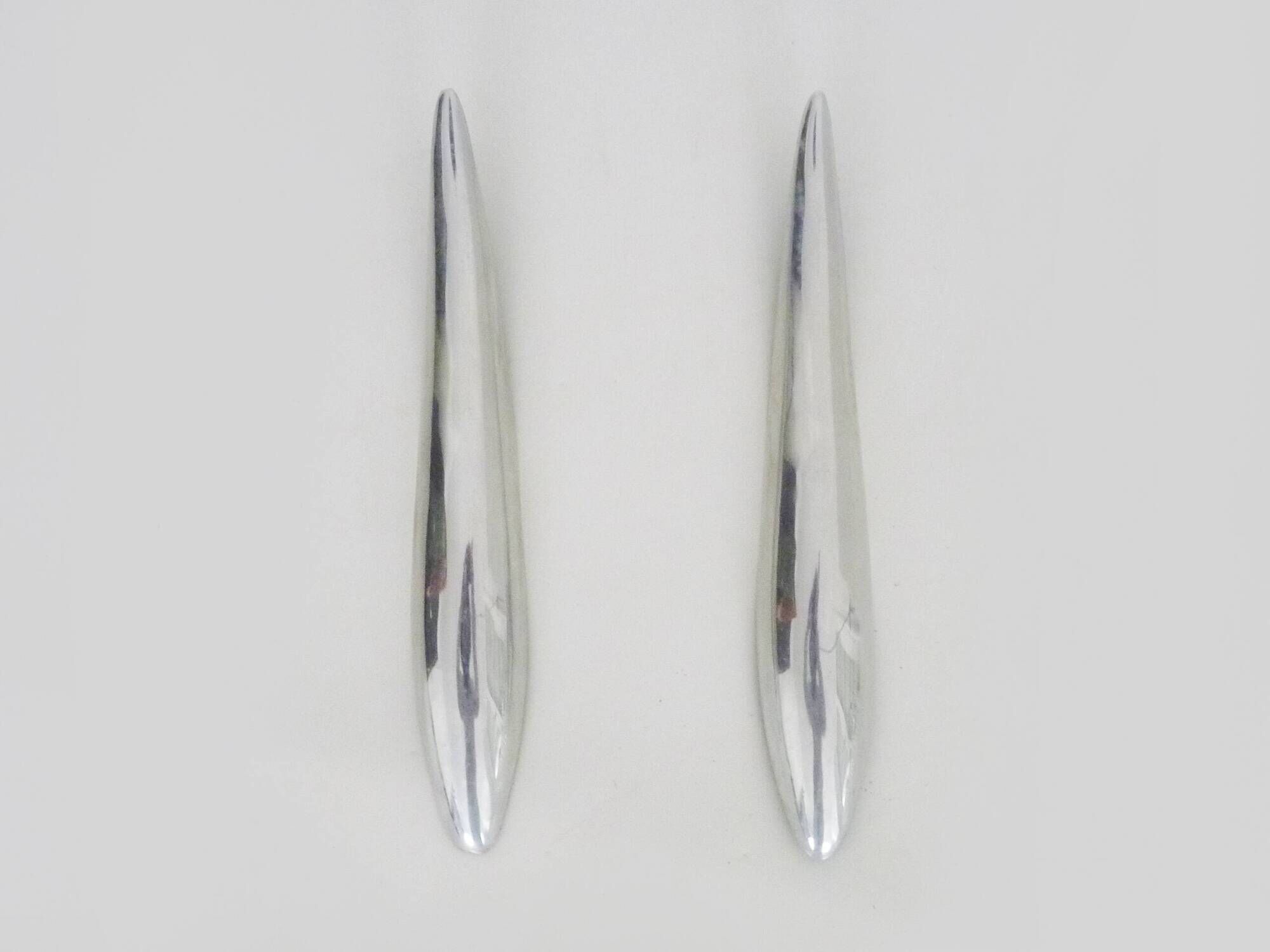 Pair of designer wall sconces in aluminium in the style of Lucien Gau.