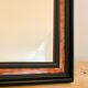 Old wall mirror 72 x 52 cm in black wood and faux mahogany
