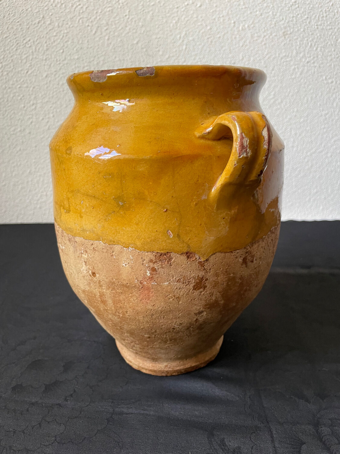 Old candied pot in yellow glazed terracotta