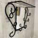Wall-mounted coat rack with its mirror.