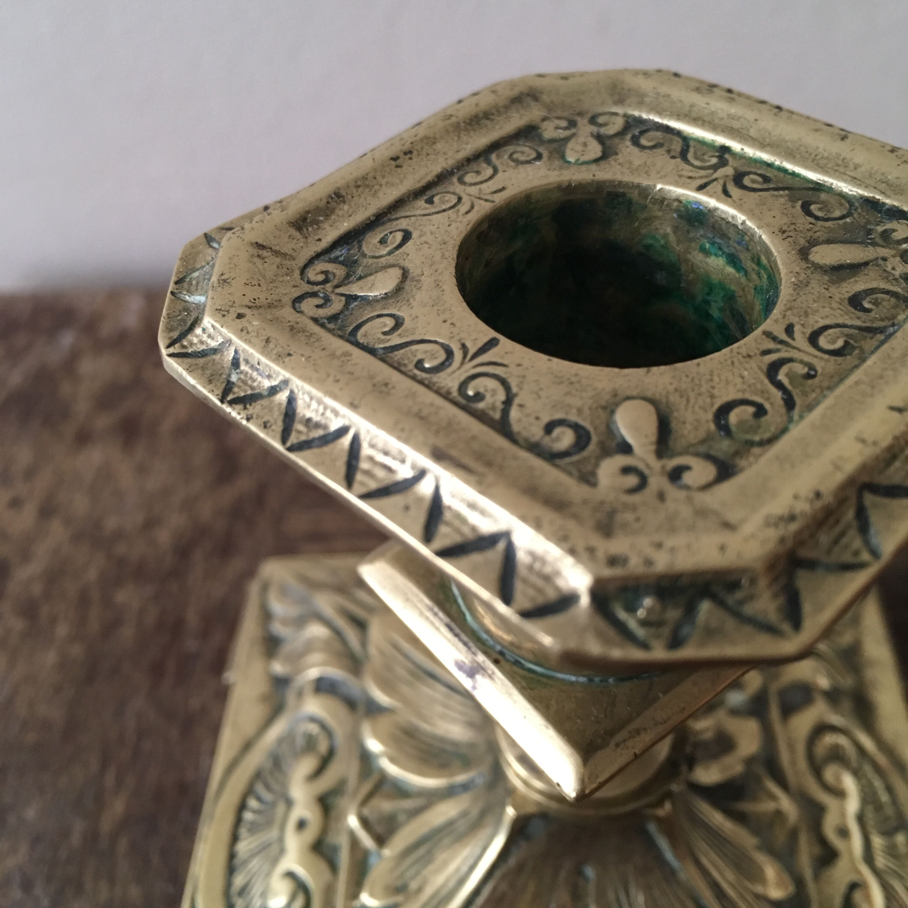 Old brass candle holder with square base