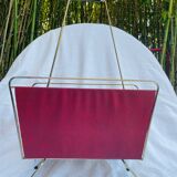 Vintage magazine rack in red skai with gold metal frame and plastic handle