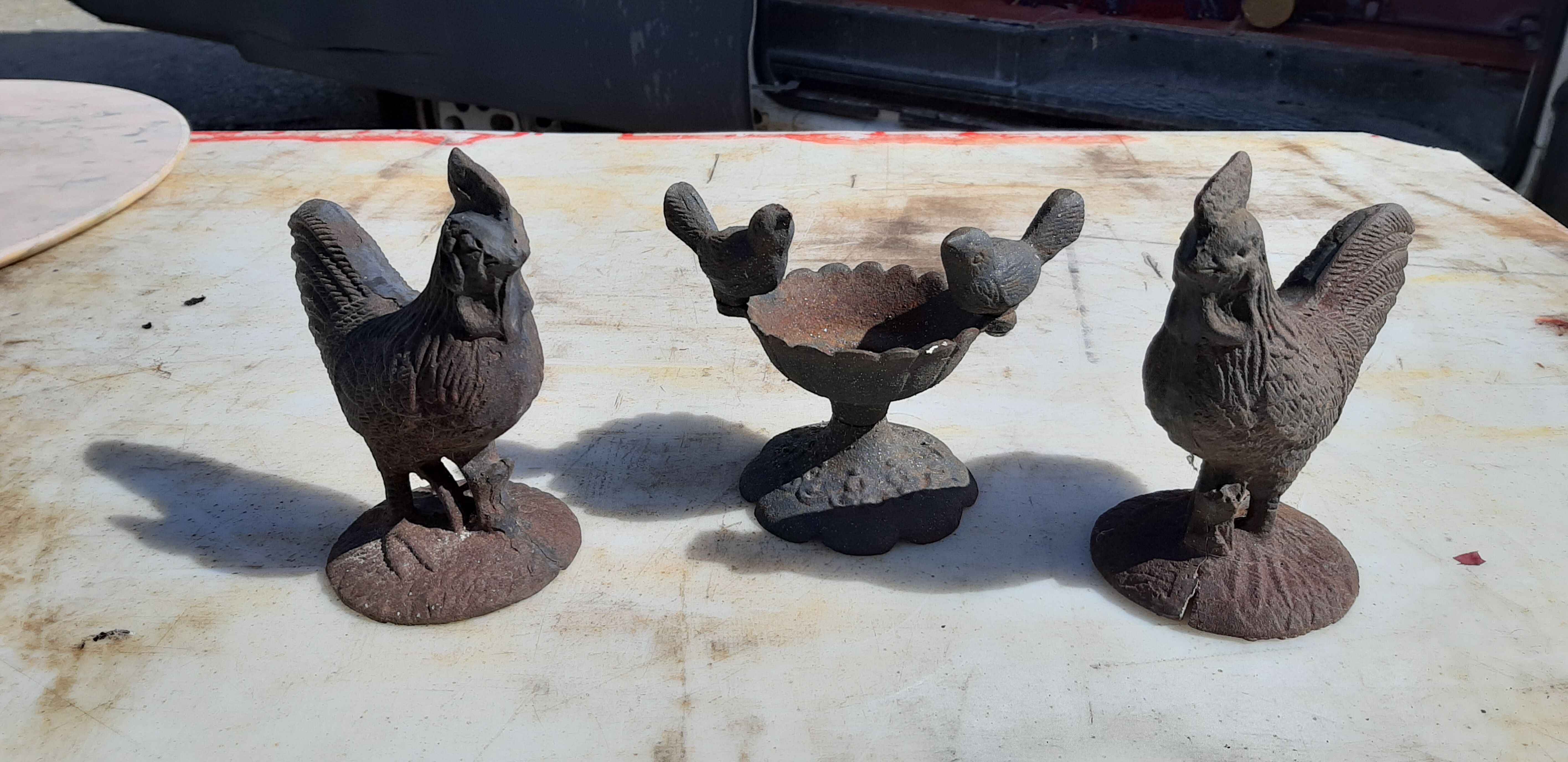 2 roosters and 2 cast iron birds