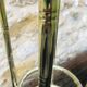 Vintage faux bamboo pedestal table in brass with 2 glass shelves