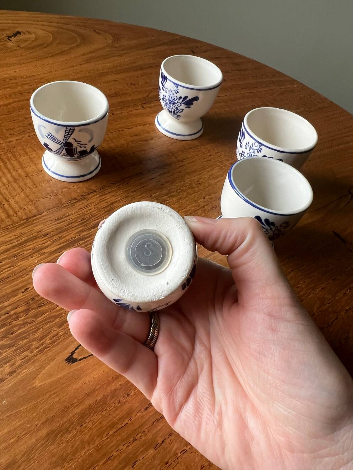Set of 4 vintage egg cups and salt shaker in blue Delft pottery.