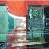 Mercedes flatbed containing drums pulling 1 trailer carrying 1 covered vehicle