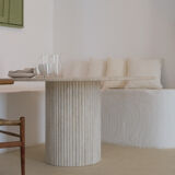 Omega circular dining table in natural travertine