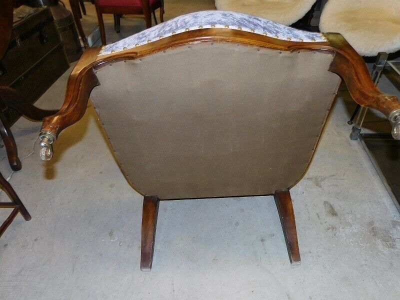 Relaxed Voltaire armchair with walnut racks