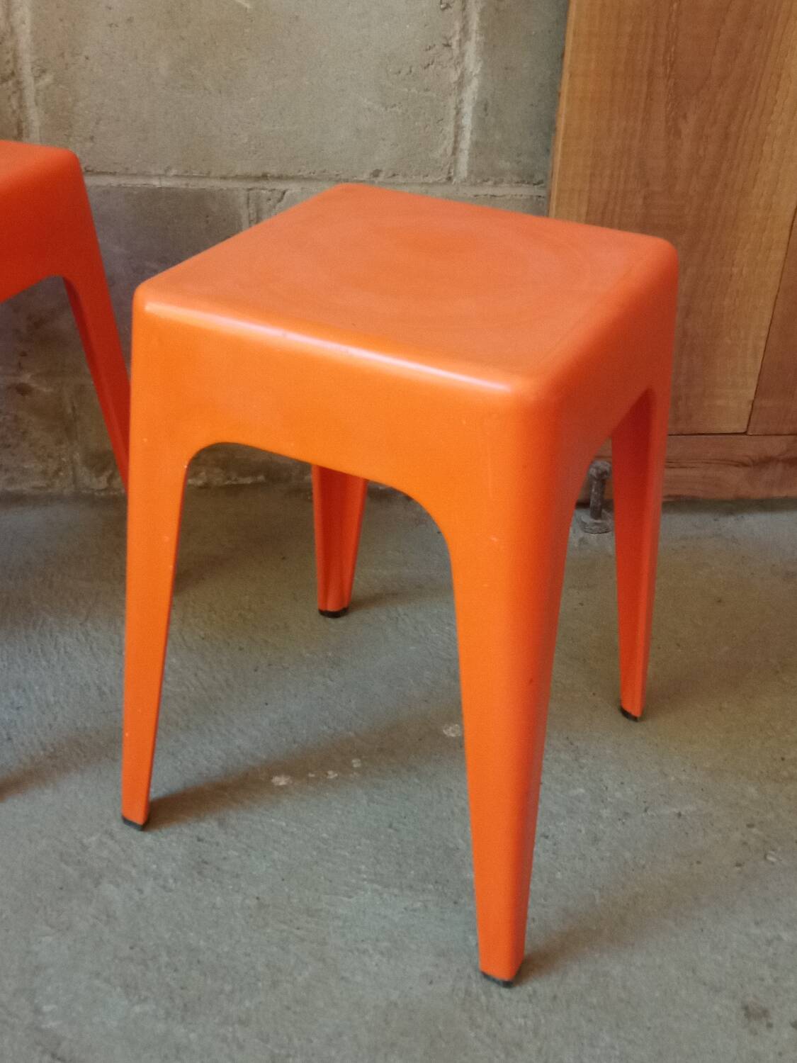 Pair of AMI stools in orange plastic