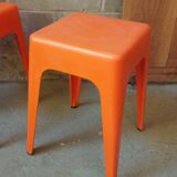Pair of AMI stools in orange plastic