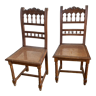 Duo of carved wooden chairs seated in tans.