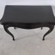 Molded blackened wooden play table, arched legs, green felt