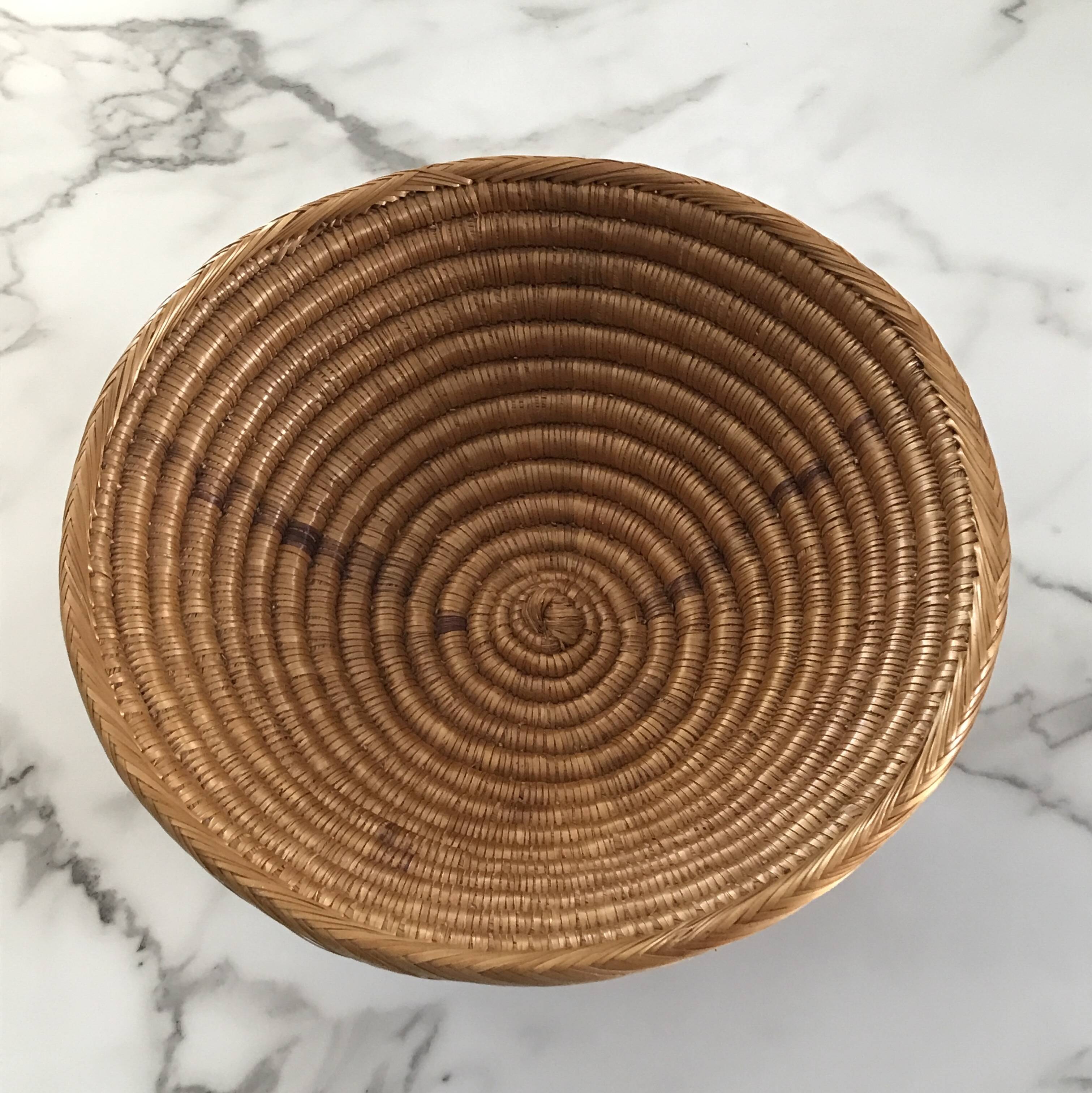 Large bowl on a woven wicker stand