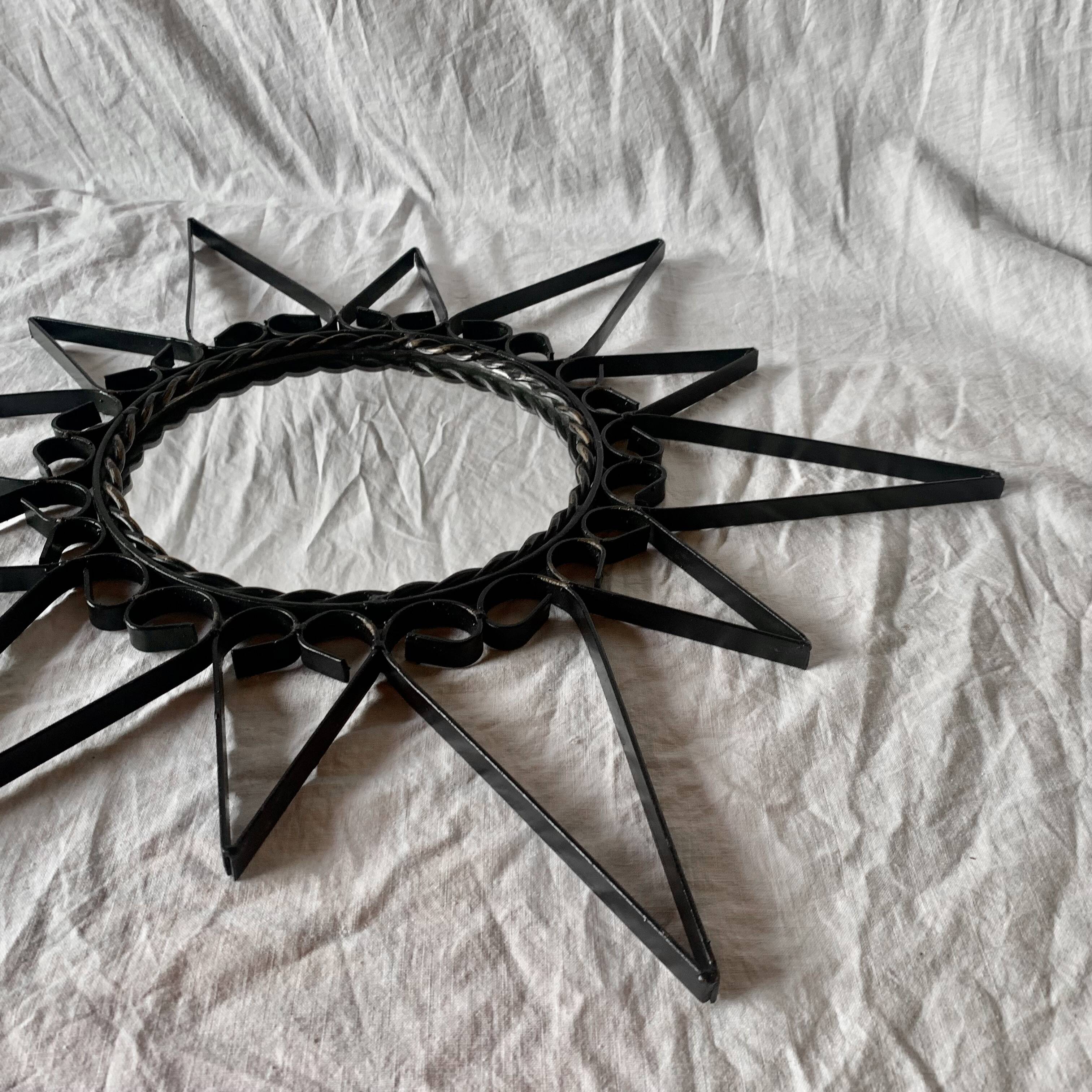 Old wrought metal sun mirror