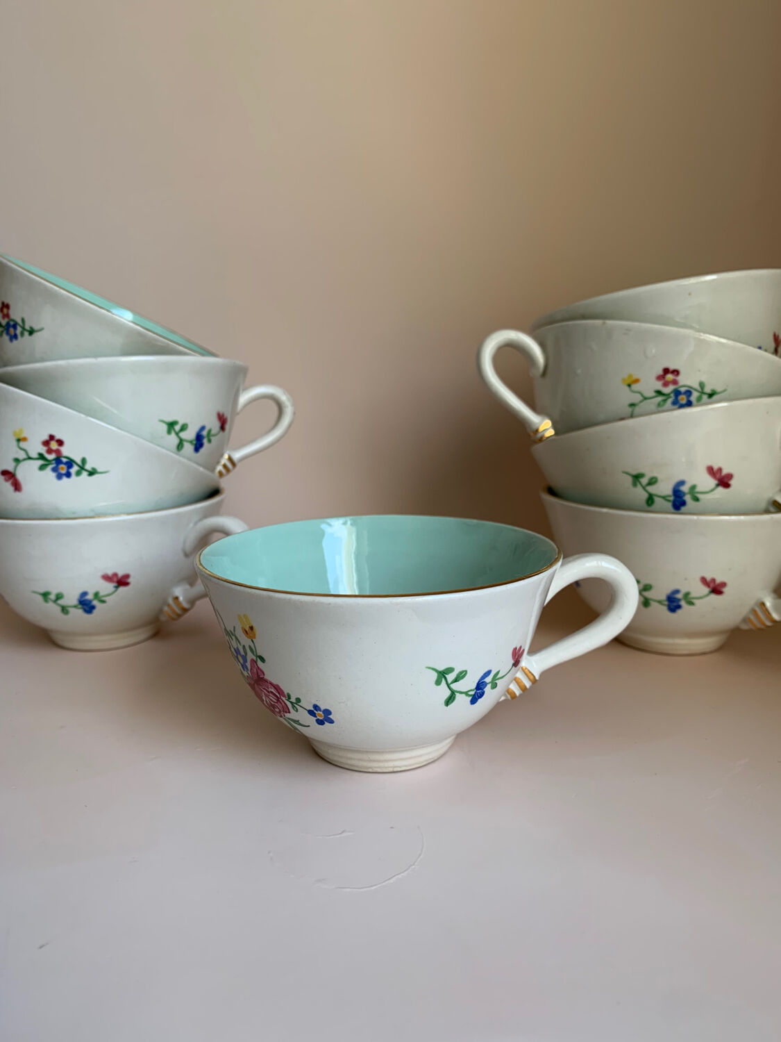 Set of 9 floral Luneville porcelain coffee cups with gold edges