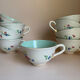 Set of 9 floral Luneville porcelain coffee cups with gold edges