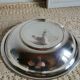 Shallow round metal plate with pearl row decoration.