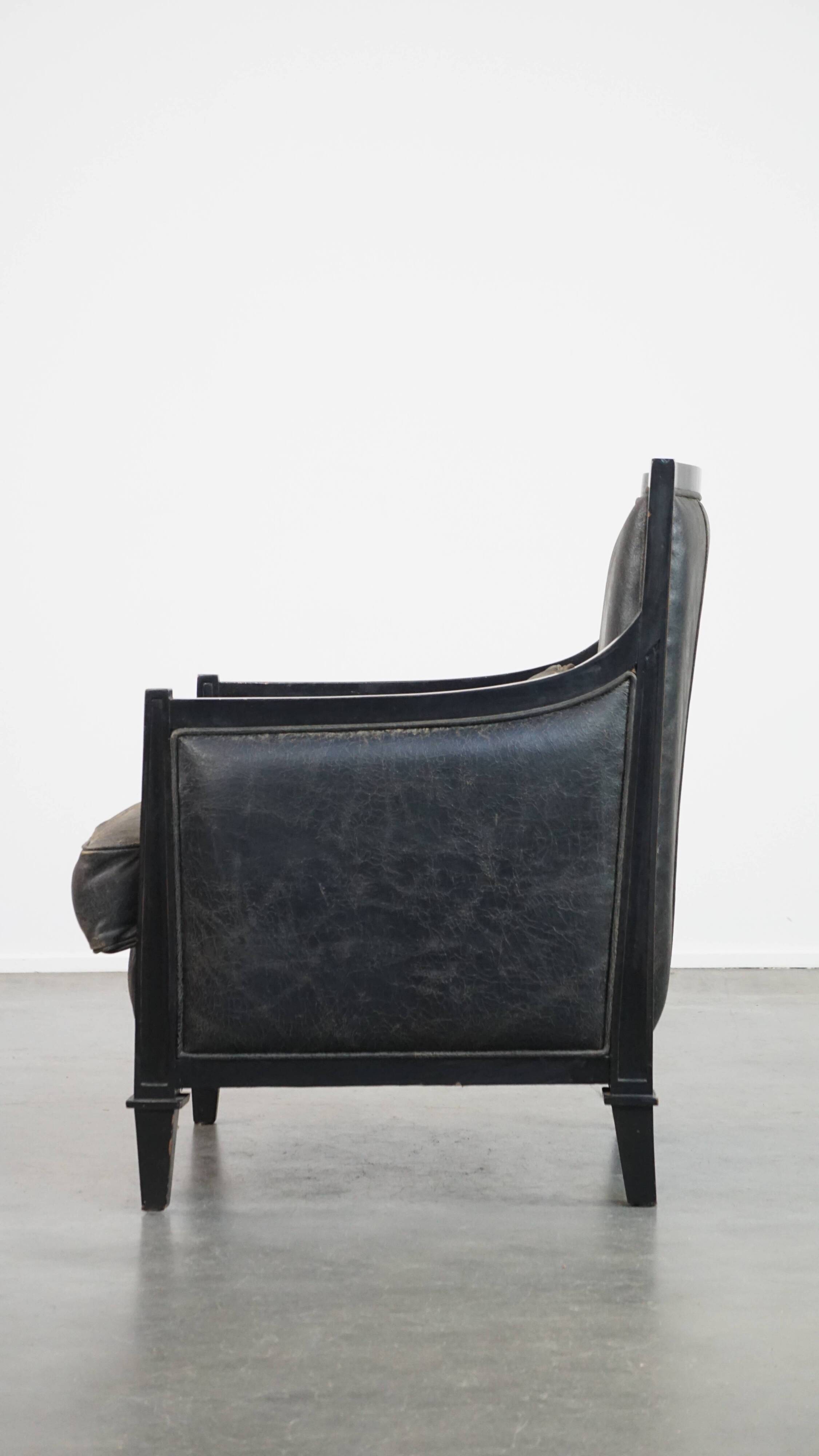 Armchair in black cowhide leather and wood with an Art Deco design