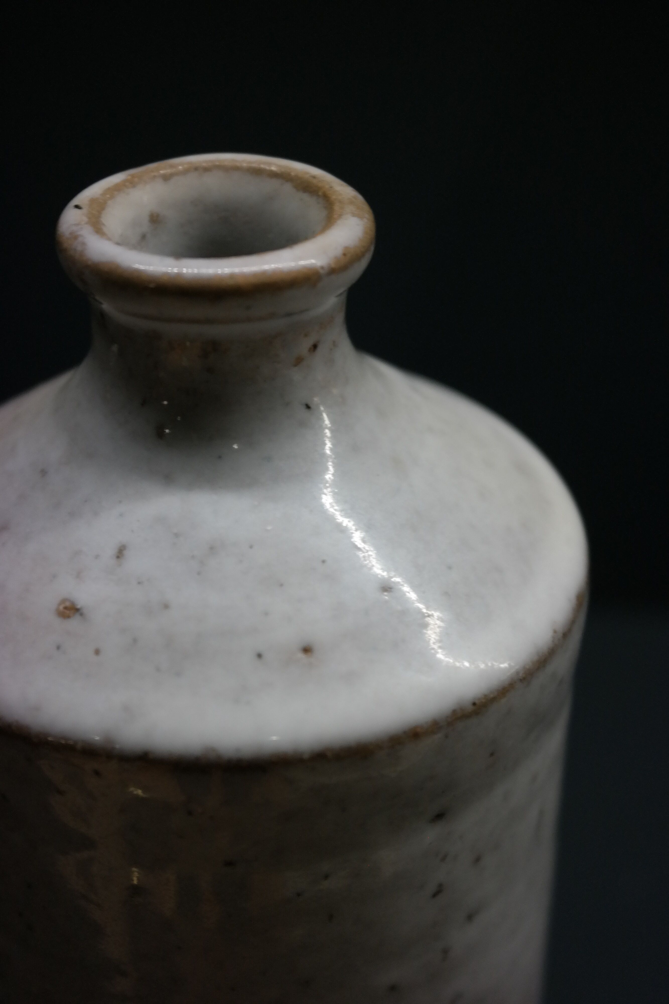 White enamelled sandstone bottle-shaped vase