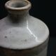 White enamelled sandstone bottle-shaped vase