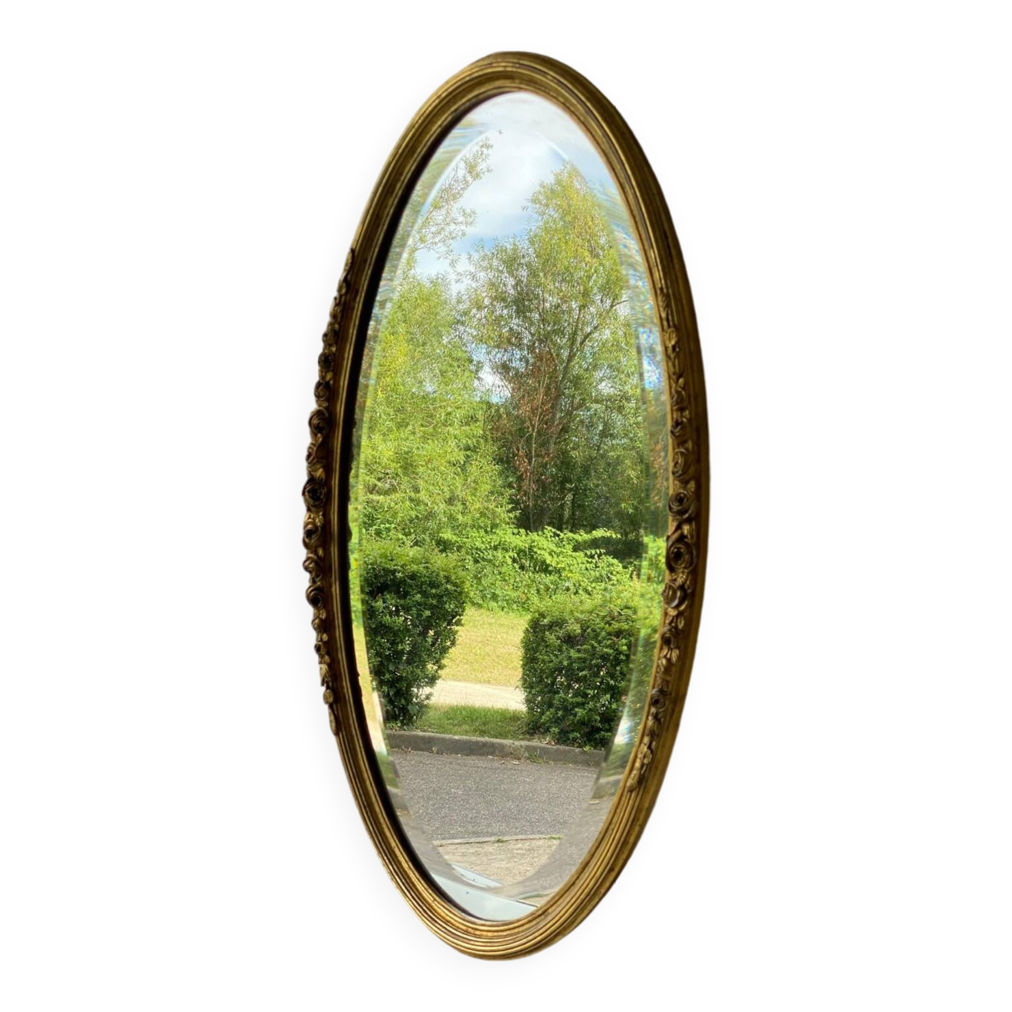 Vintage carved and gilded oval wall mirror