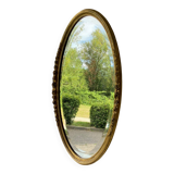 Vintage carved and gilded oval wall mirror