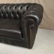Two seater black leather chesterfield sofa