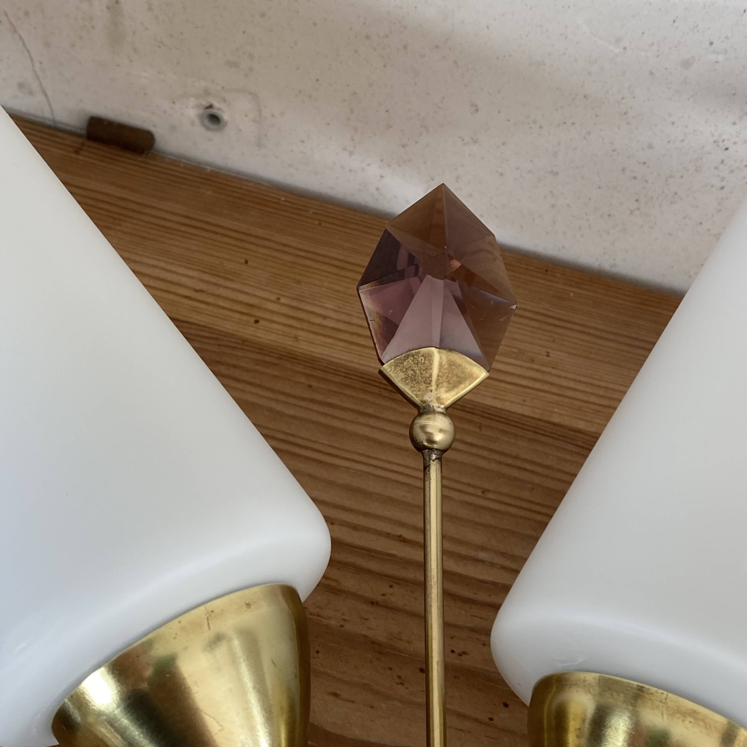 Pair of wall sconces in brass with white glass tulips.