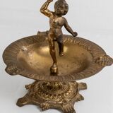 Vintage brass ashtray from the 1940s with a nude boy figurine on a footed base.