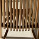 Foldable designer armchair in wooden slats