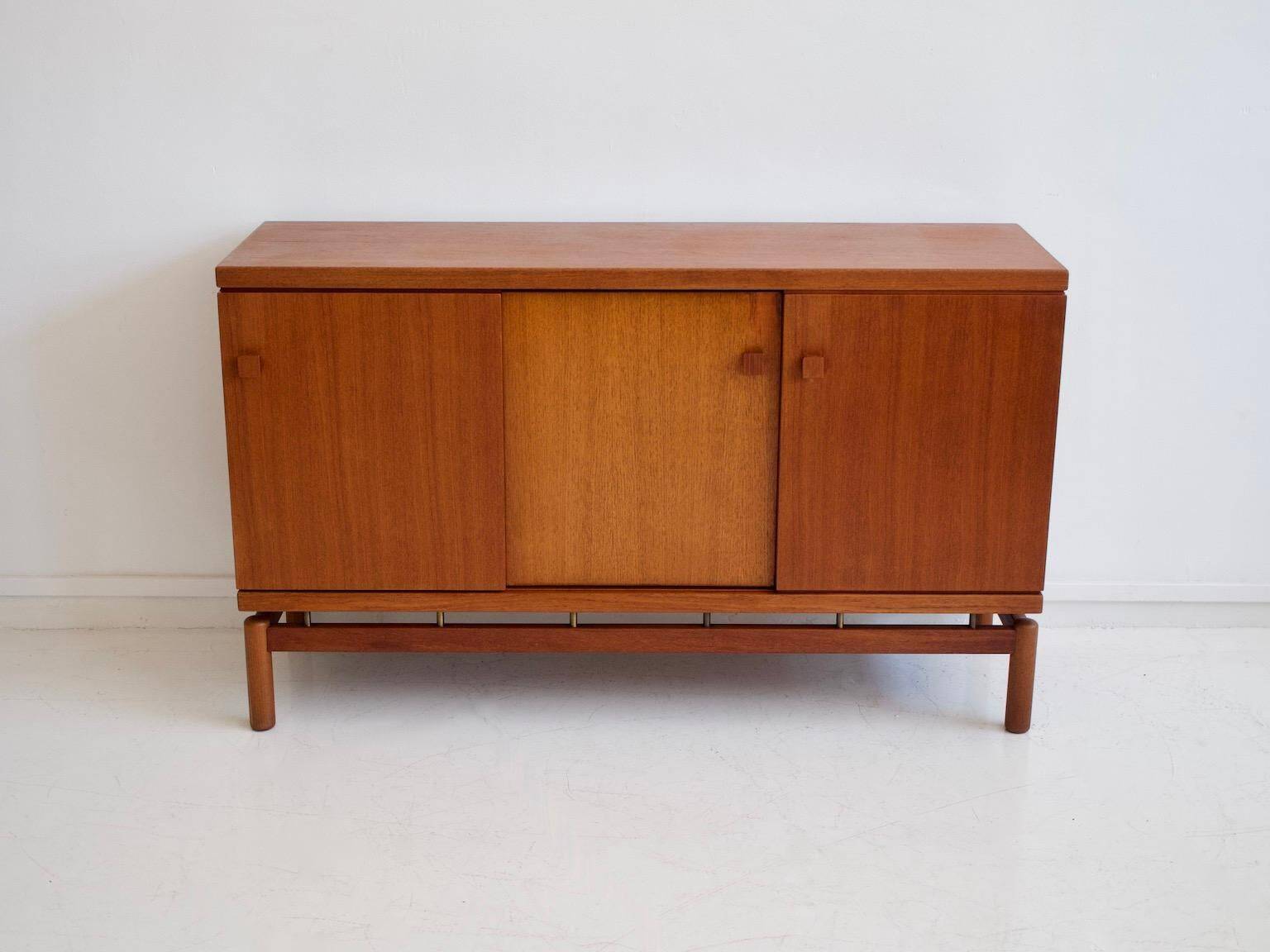 Modern mid-century teak sideboard with brass details.