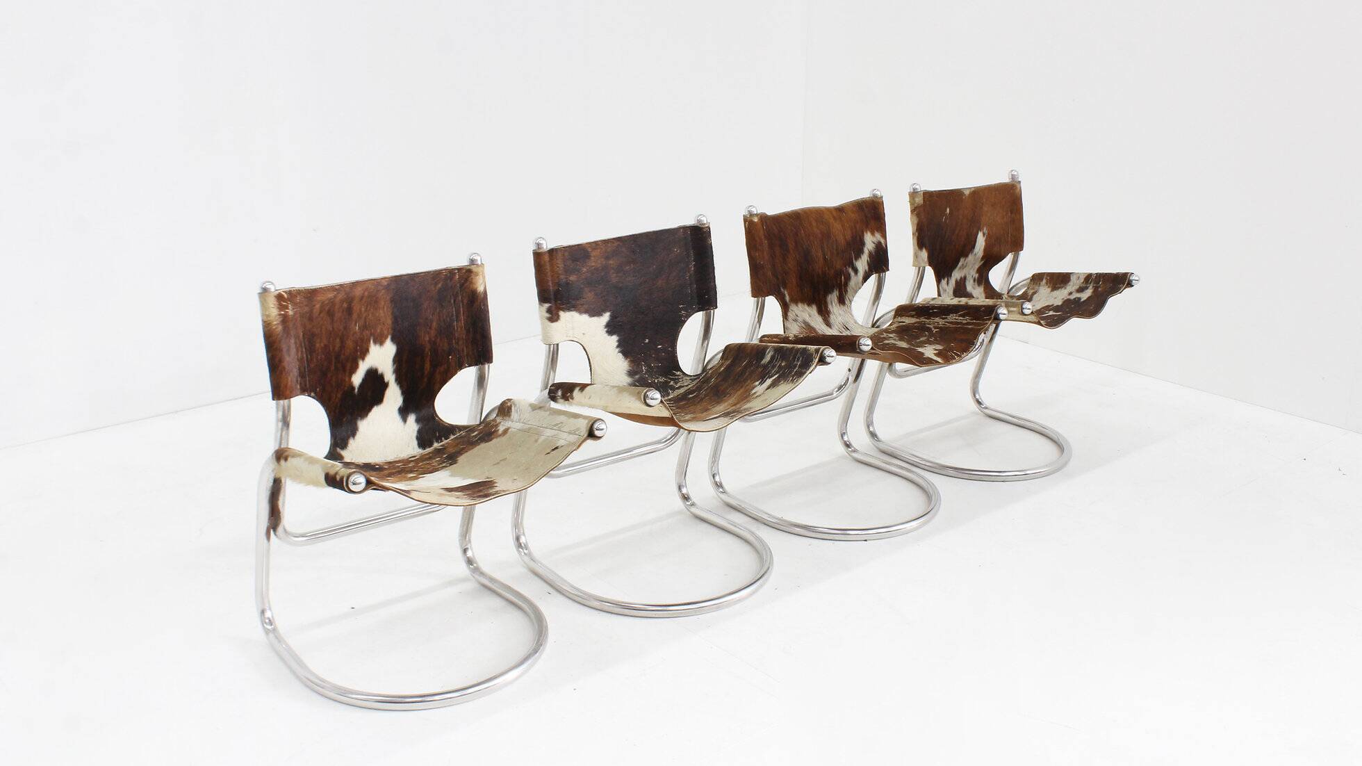 Vintage dining room chairs chrome and cowhide by Parravicini Fratelli