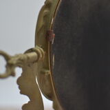 Adjustable psyche mirror of 33 centimeters in gilded bronze with angel ornament