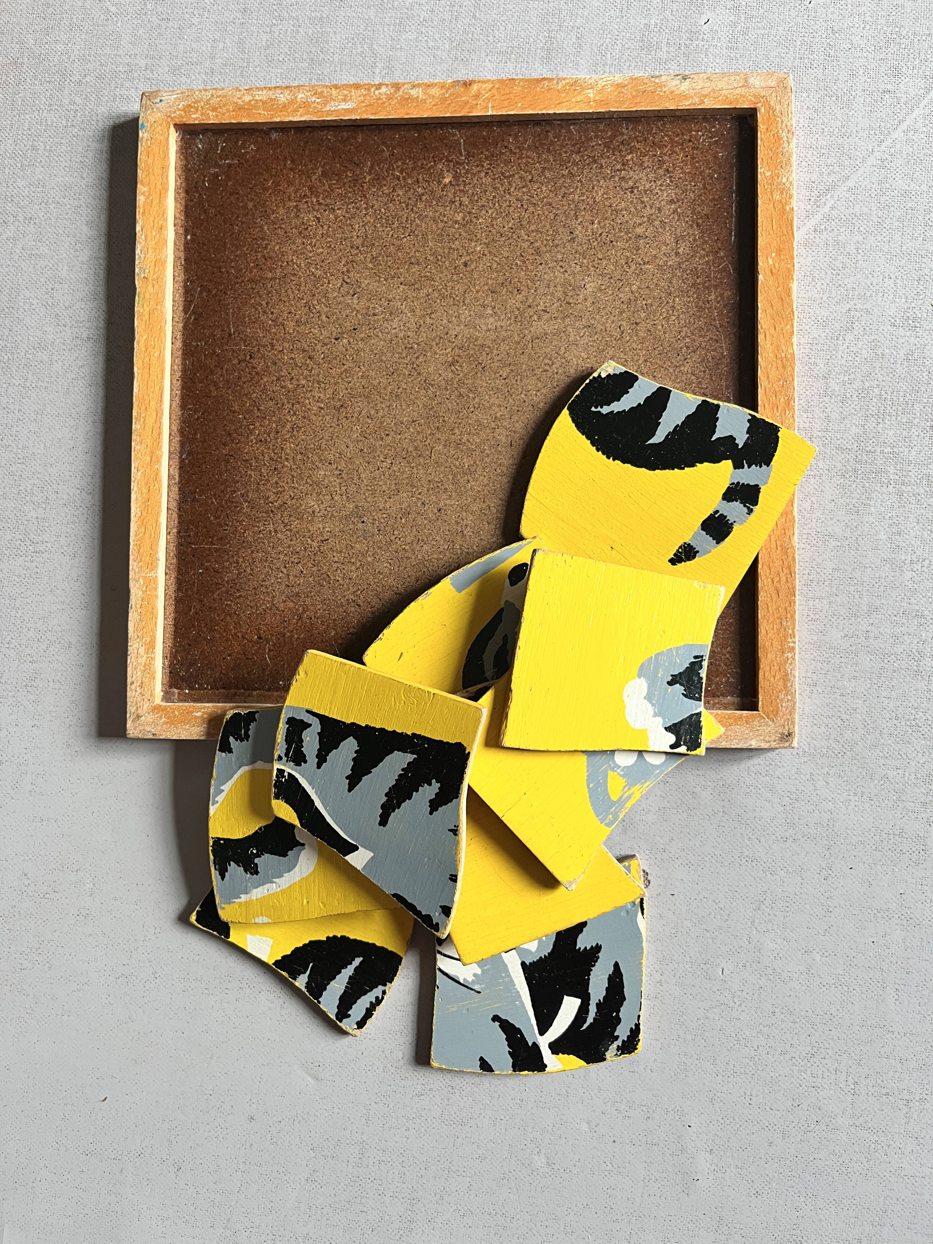 Wooden frame puzzle from the 1940s/50s depicting a cat on a yellow background.