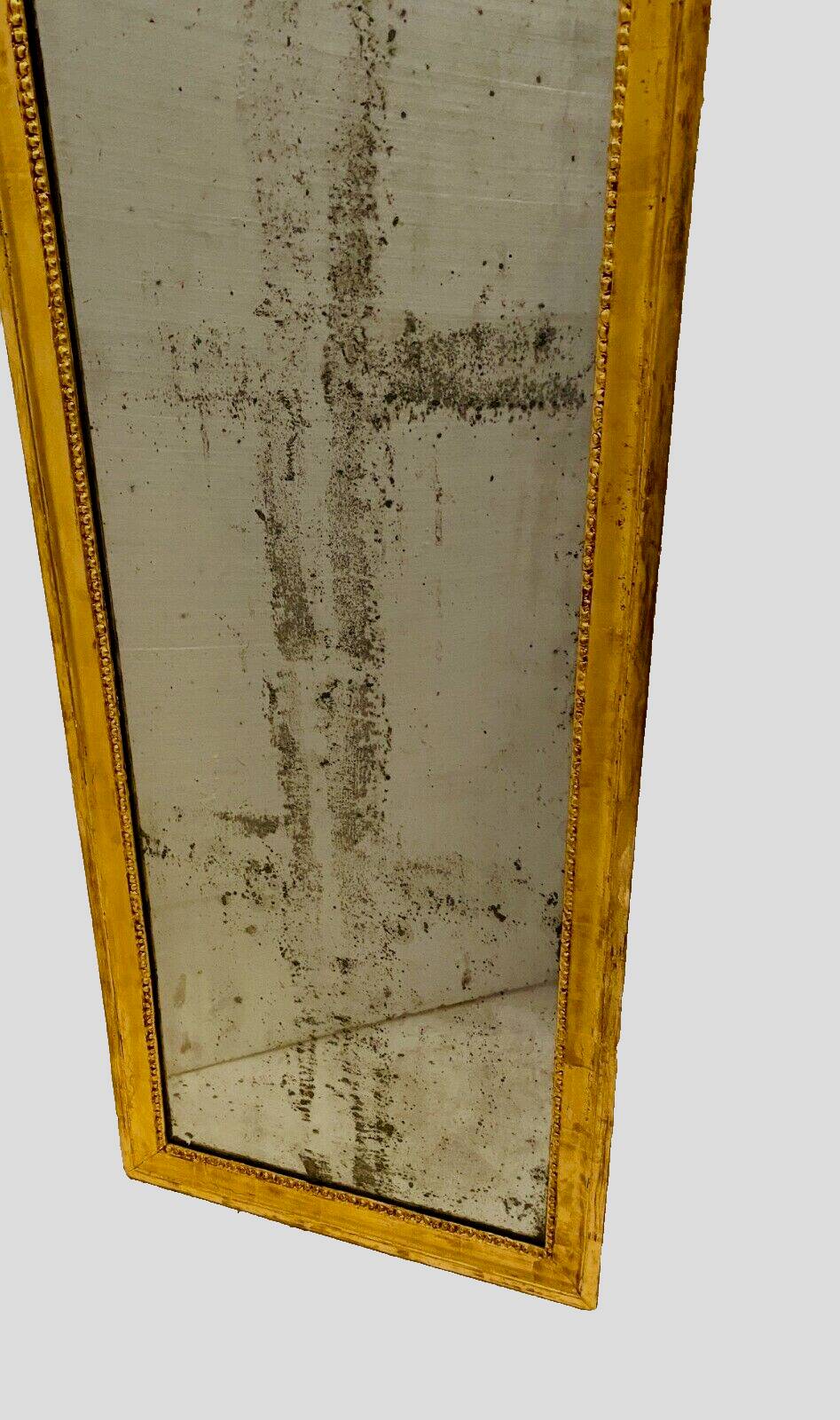 Louis XVI mirror in carved and gilded wood with leaf 18th century