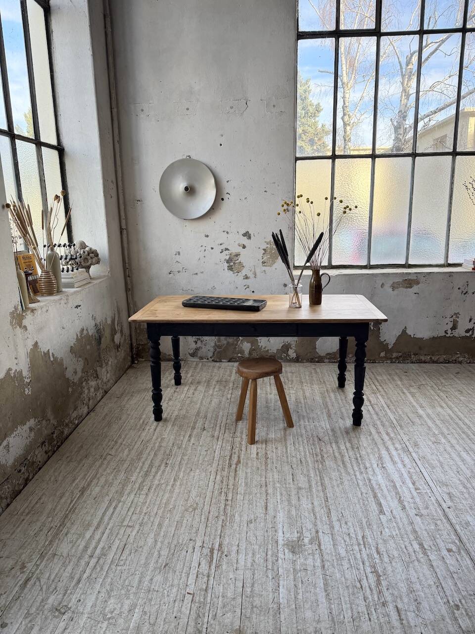 Oak farmhouse table with turned black legs.