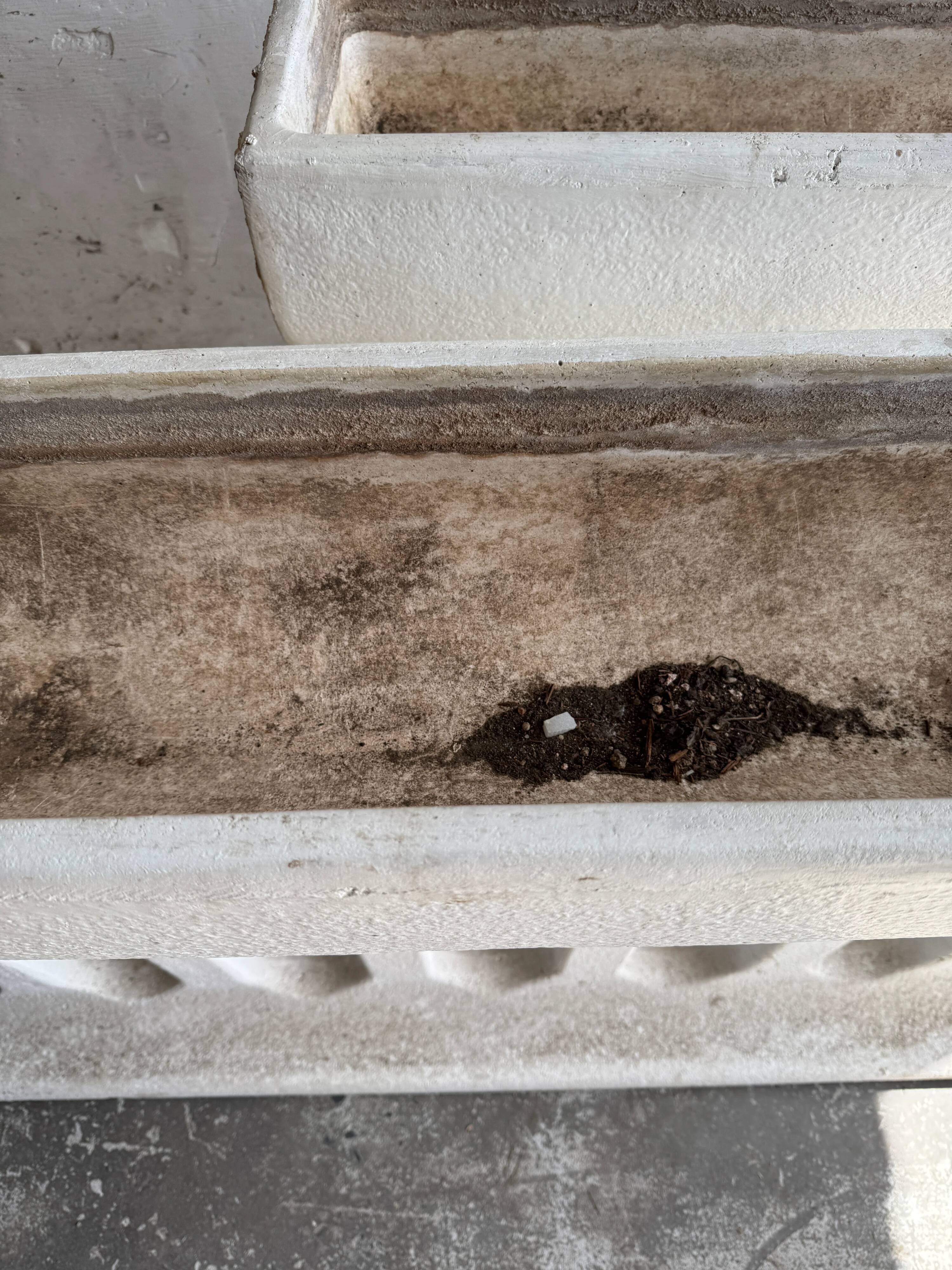 Pair of sculptural cast concrete planters in Off-White, mid-century brutalist style, long and rectangular.