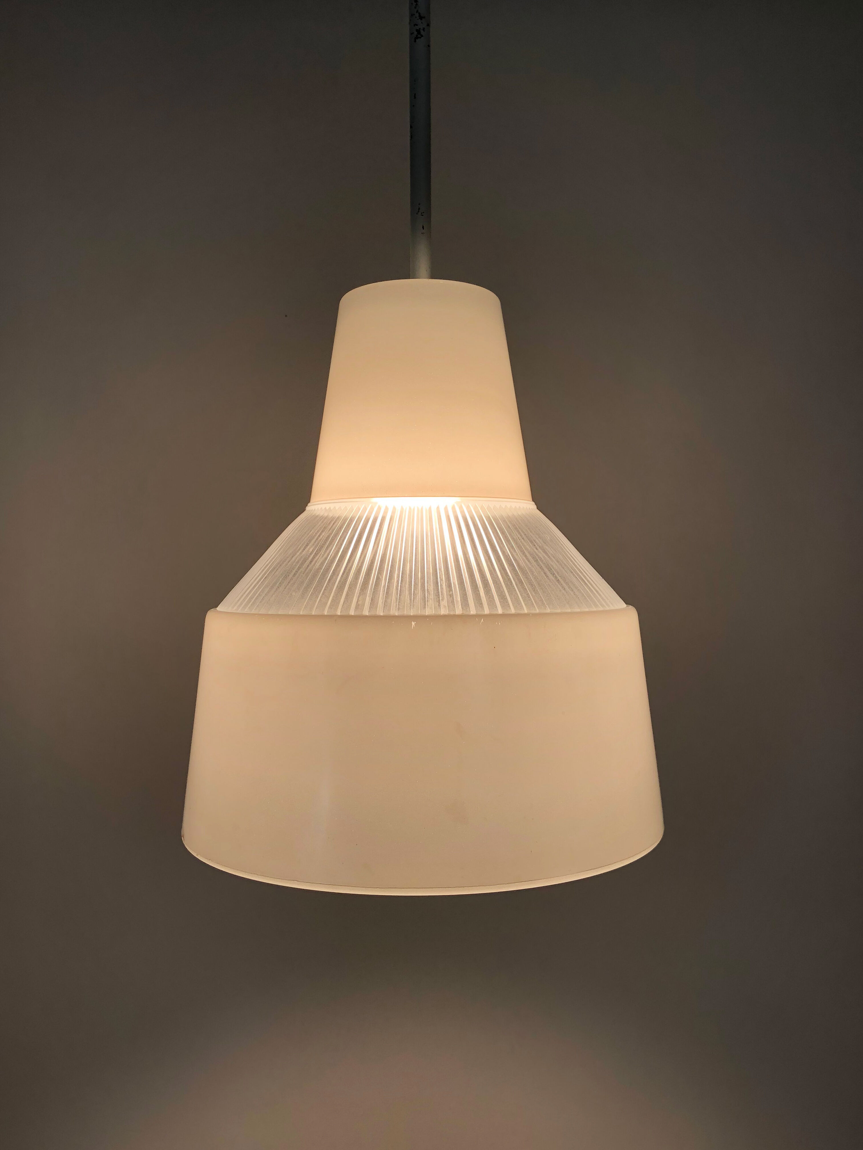 Vintage industrial suspension in glass and metal rod, factory, workshop, garage. Year 50