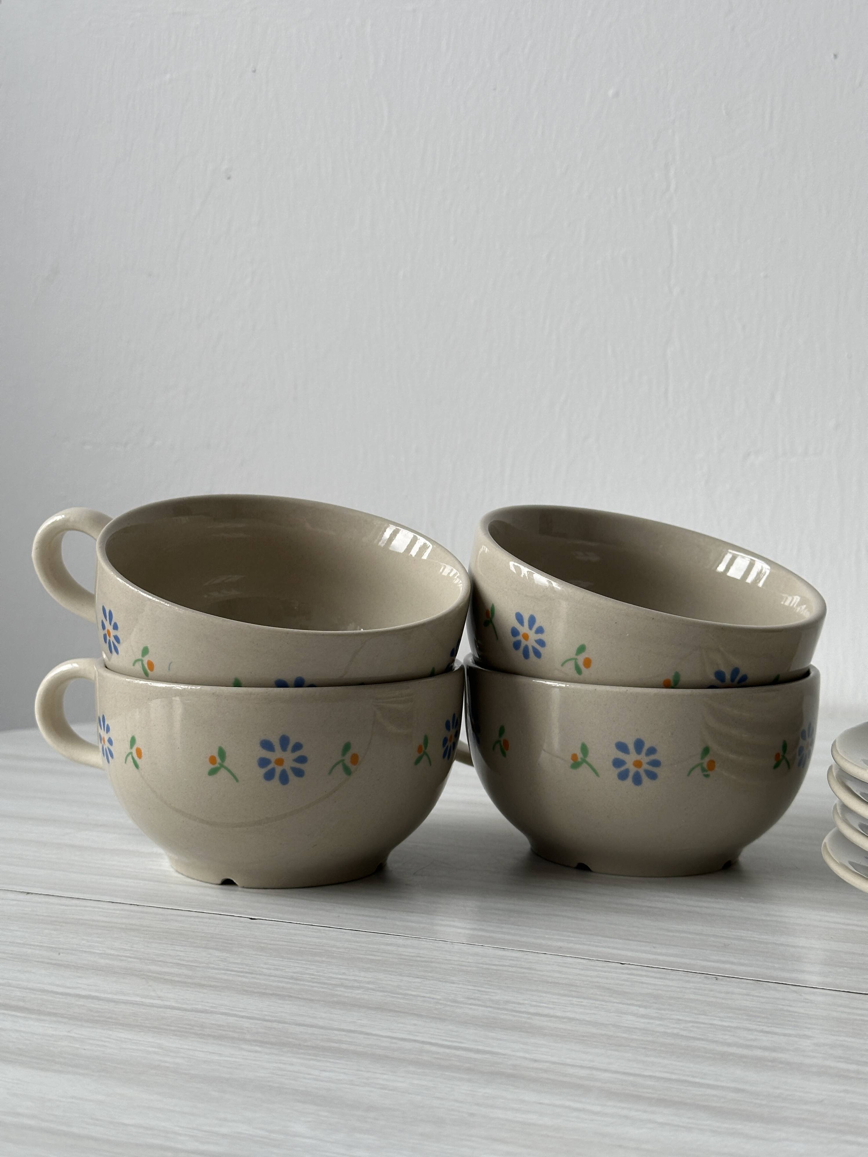 Ceramic cups and saucers with flower decoration