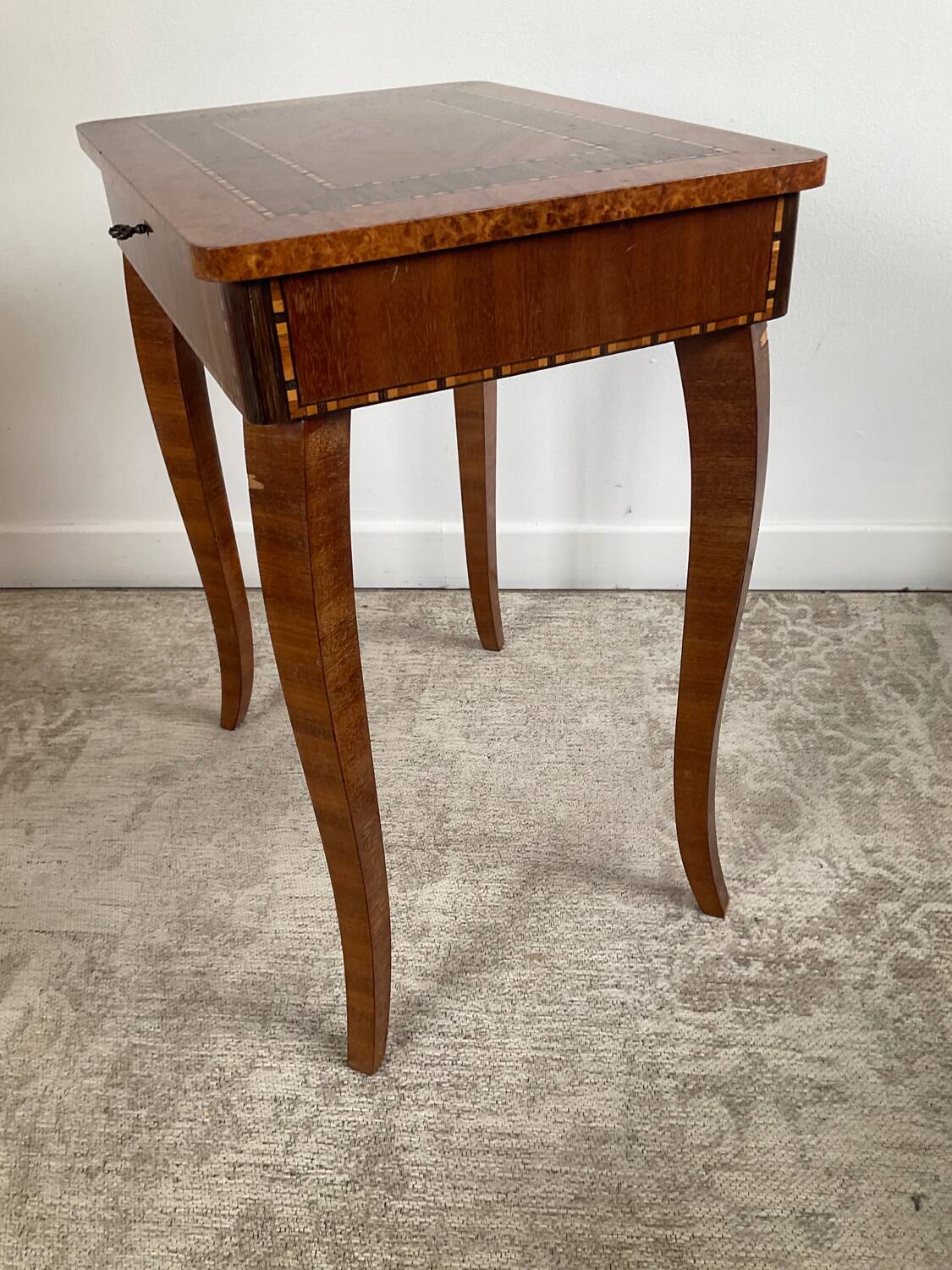 Small marquetry pedestal table with key storage