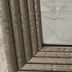 Textured embossed metal wall mirror with bevelled mirror.