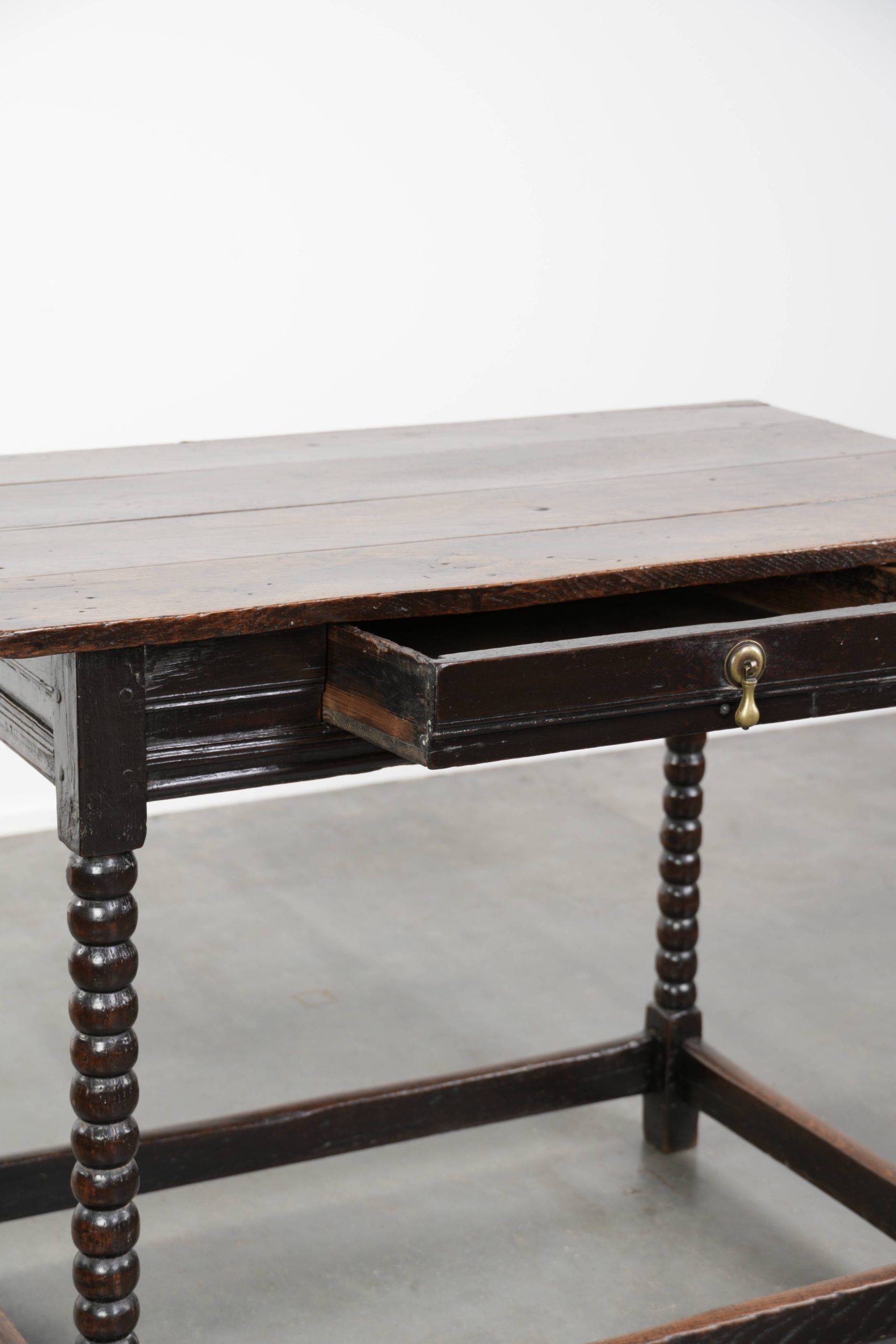 Antique English oak side table from the 18th century with bobbin legs