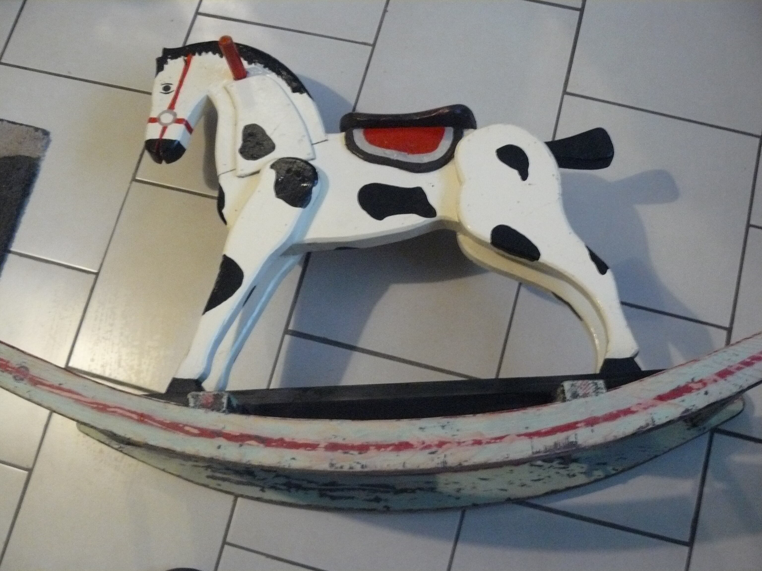 Old rocking horse in painted wood