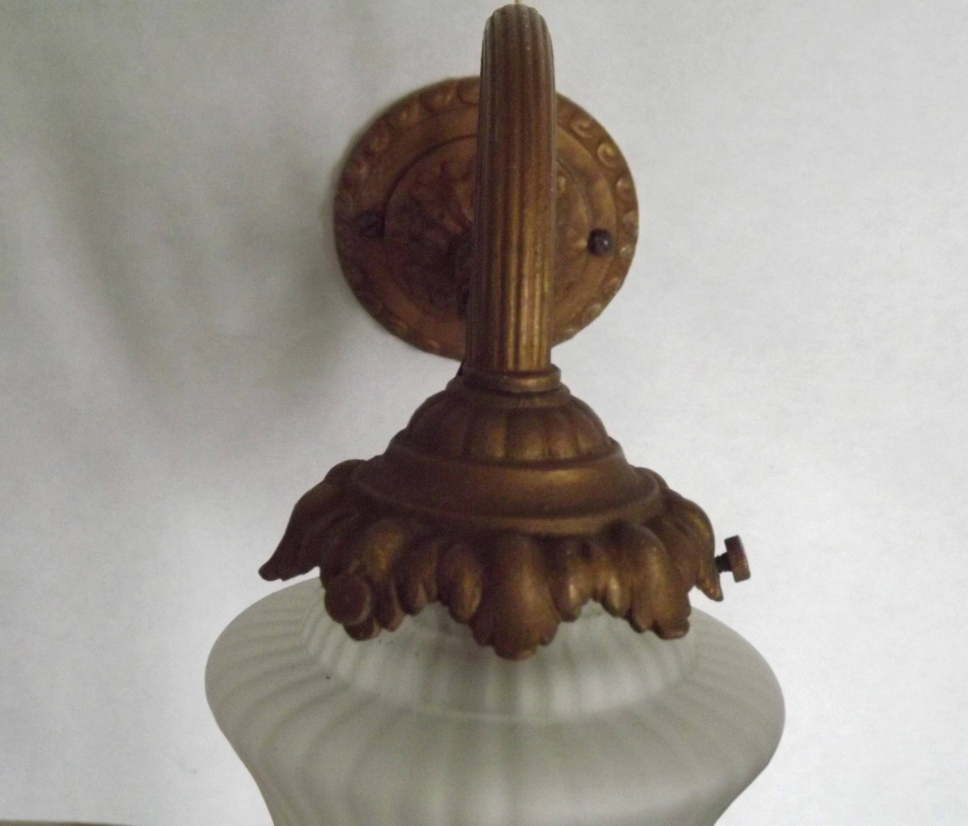 French Art Nouveau wall sconce in bronze with a white and pink glass shade.