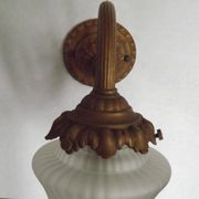 French Art Nouveau wall sconce in bronze with a white and pink glass shade.